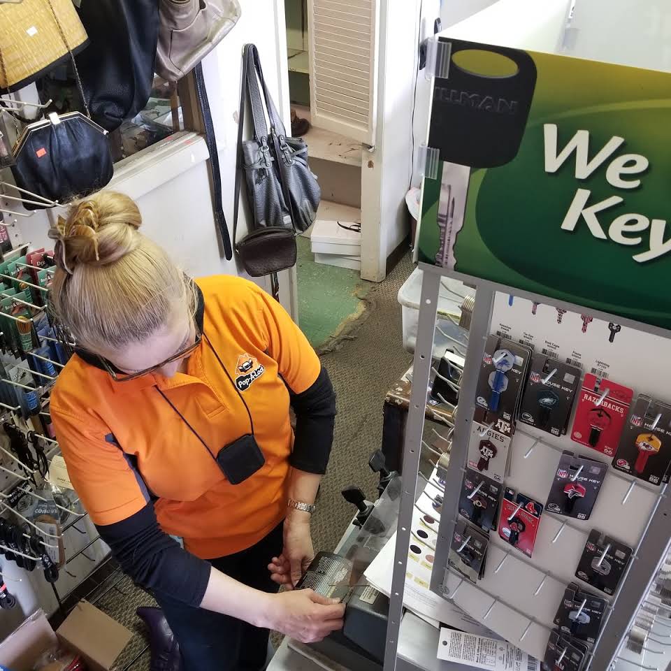 Pop-A-Lock locksmith preparing keys at the local service counter